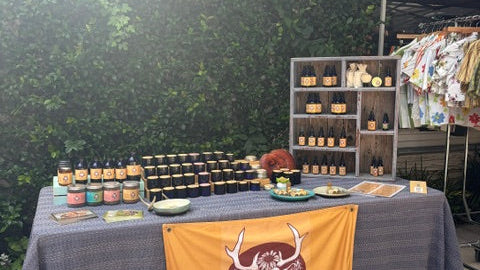 Top-down view of a table with various items including bottles and a yellow bag with a logo.